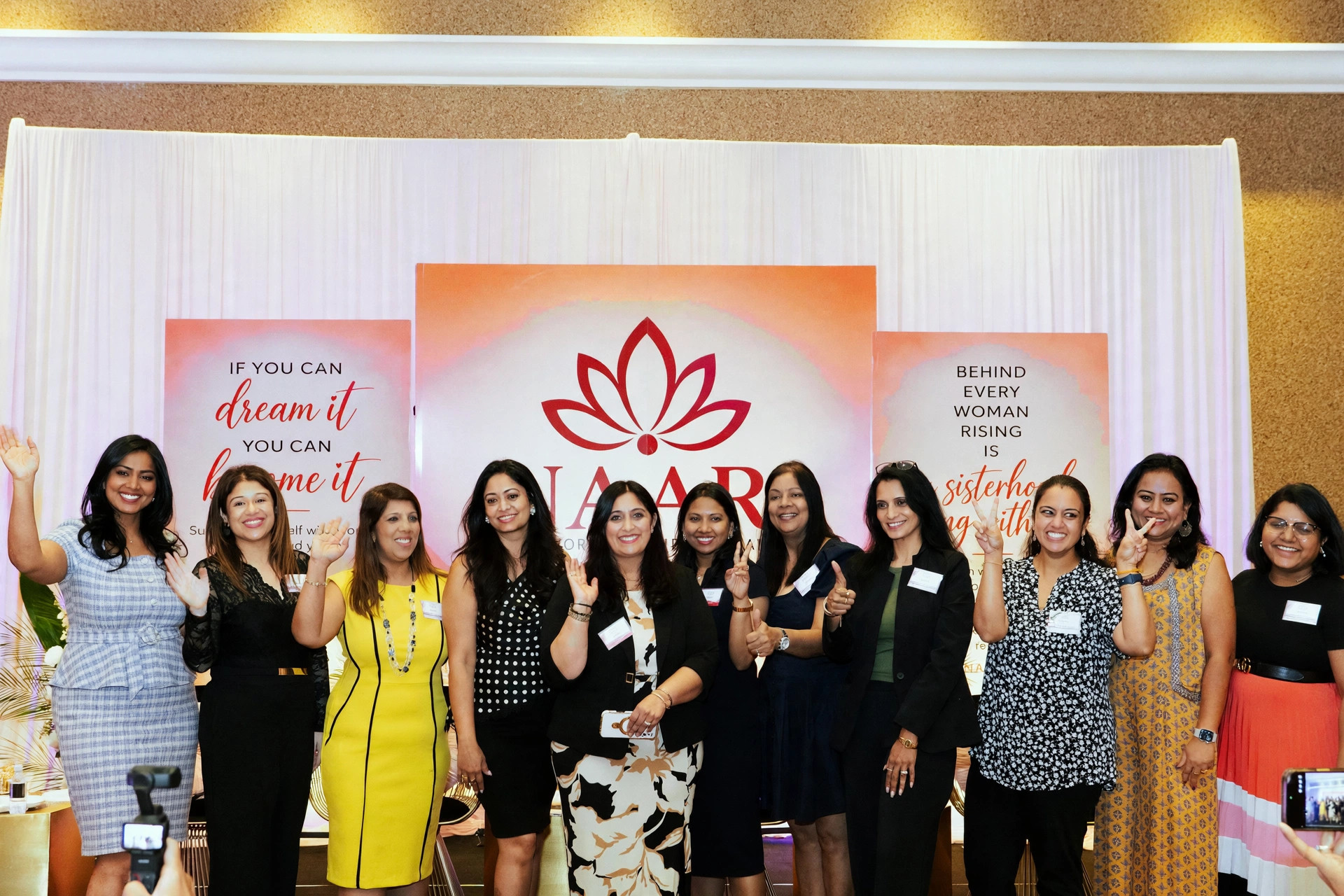 Ten women gathered with dream it and become it signage